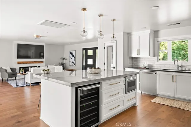a kitchen with a sink stove and cabinets