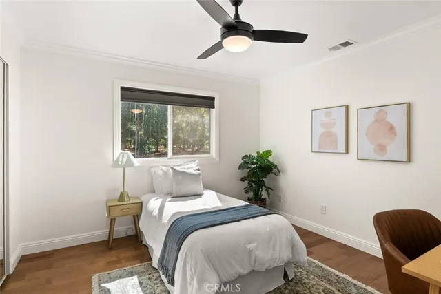 a bedroom with a large bed and a window