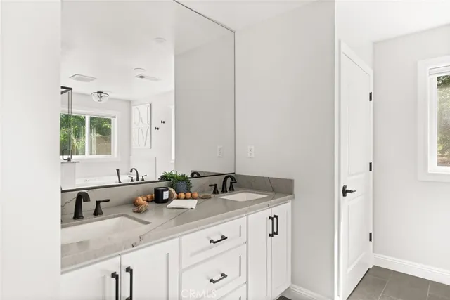 a living room with furniture kitchen view and a window