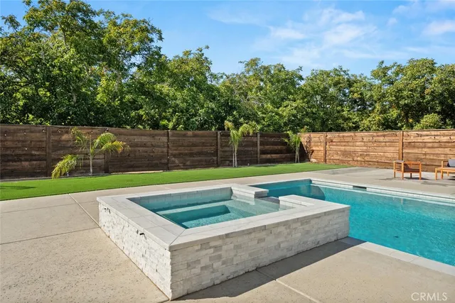 a backyard of a house with table and chairs