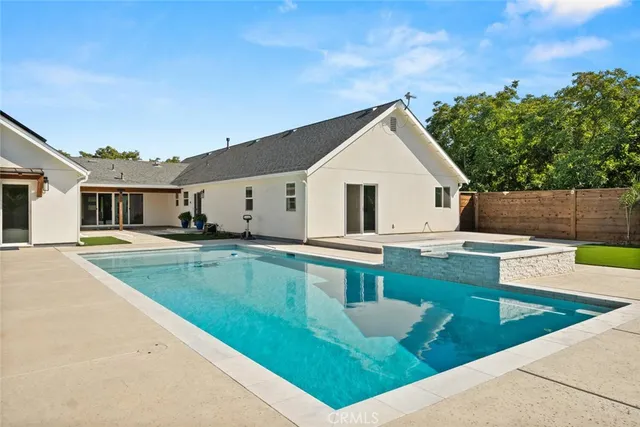 an aerial view of house with yard swimming pool and outdoor seating