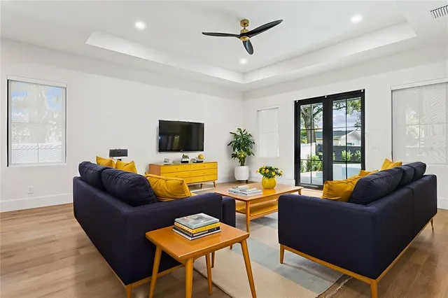 an empty room with a ceiling fan and wooden floor