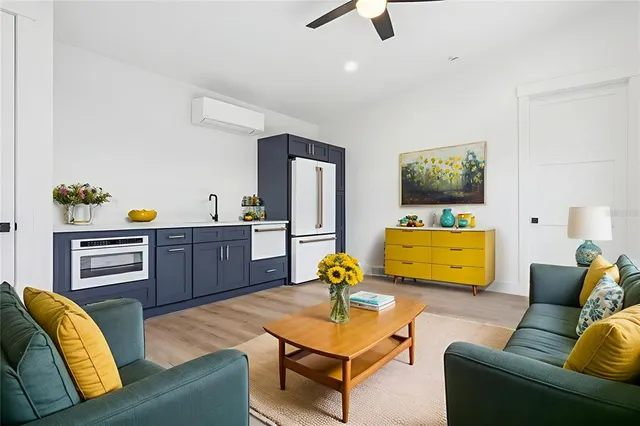 an aerial view of a city with lots of residential buildings ocean and mountain view in back