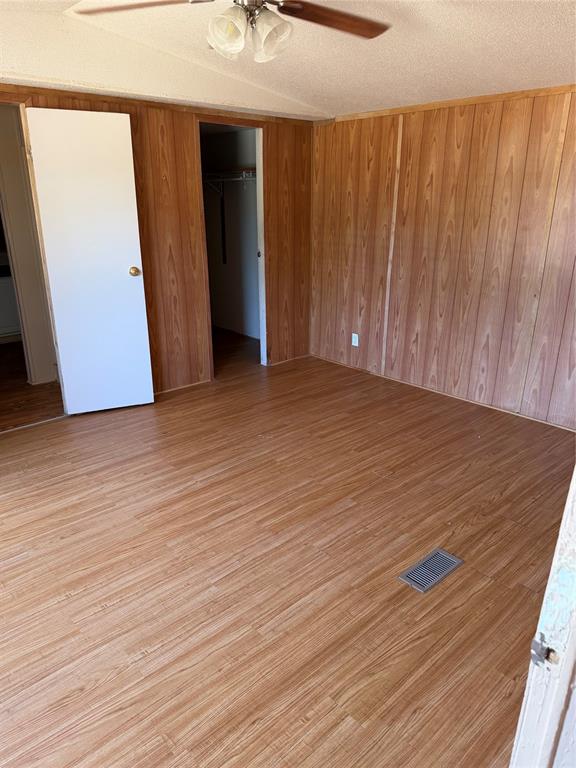 128 Rommel Court Springtown, TX 76082 - Photo 9 of 15 Wood-finish flooring with coordinating wood-paneled walls