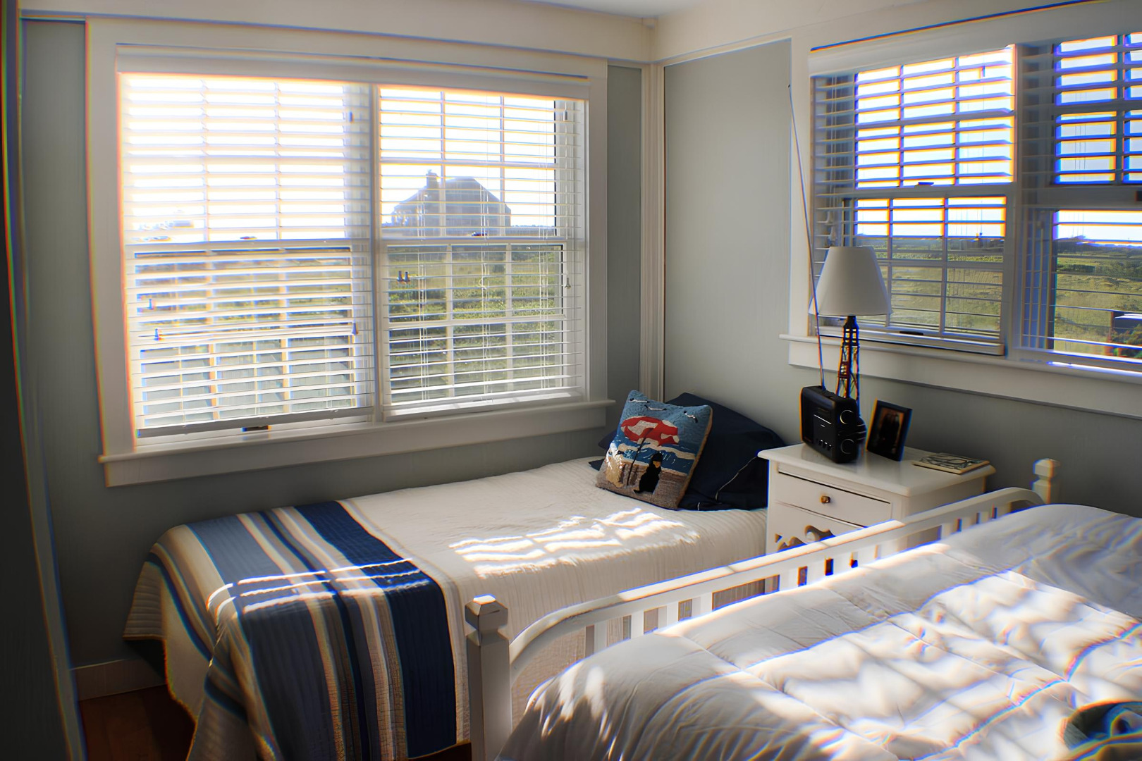 48 Madequecham Valley Road Nantucket, MA 02554 - Photo 9 of 20 a bedroom with two beds and a large window