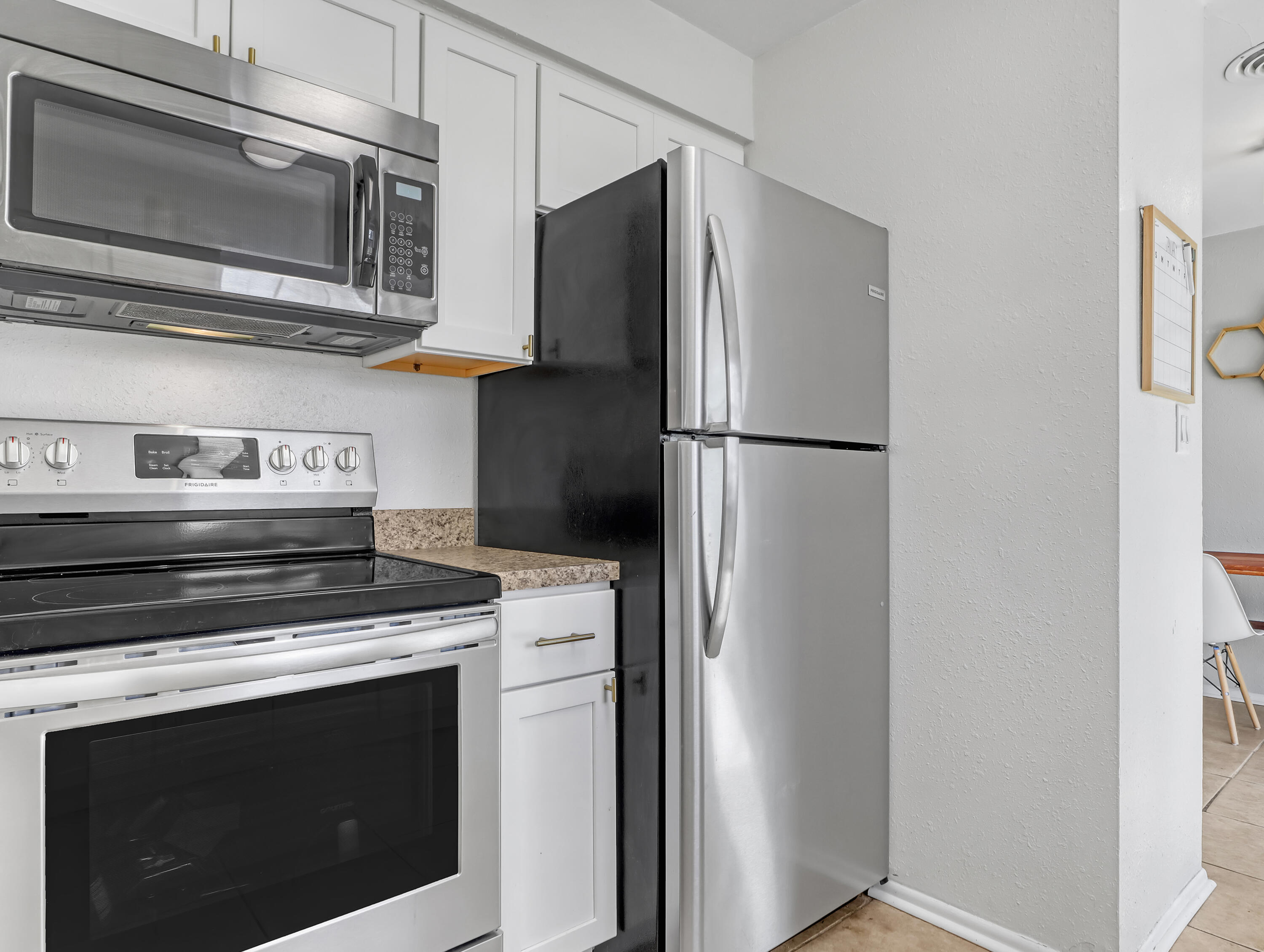 2711 Locksley Road Melbourne, FL 32935 - Photo 13 of 34 a kitchen with stainless steel appliances a stove microwave and refrigerator