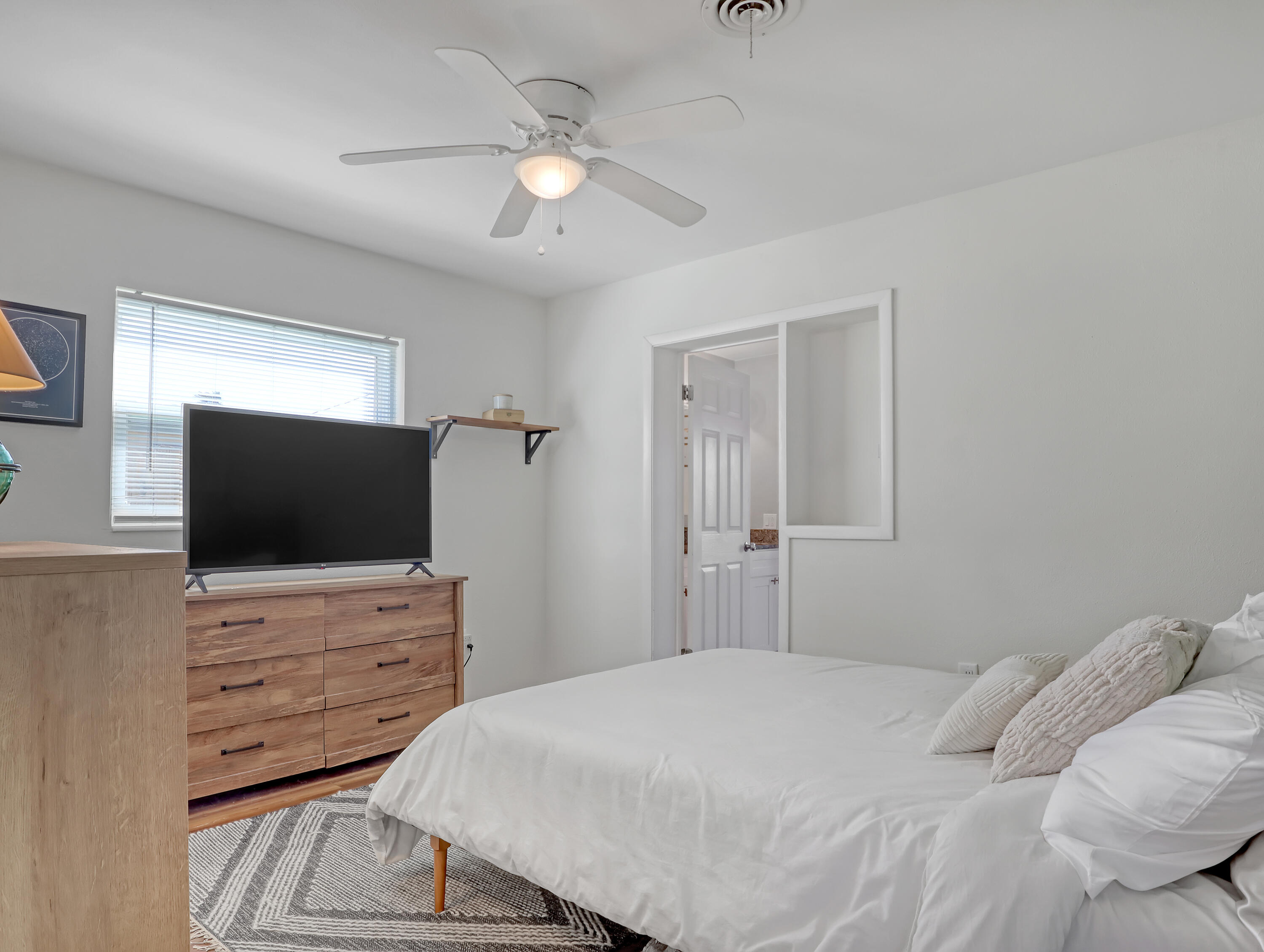 2711 Locksley Road Melbourne, FL 32935 - Photo 17 of 34 a bedroom with a bed and a flat screen tv