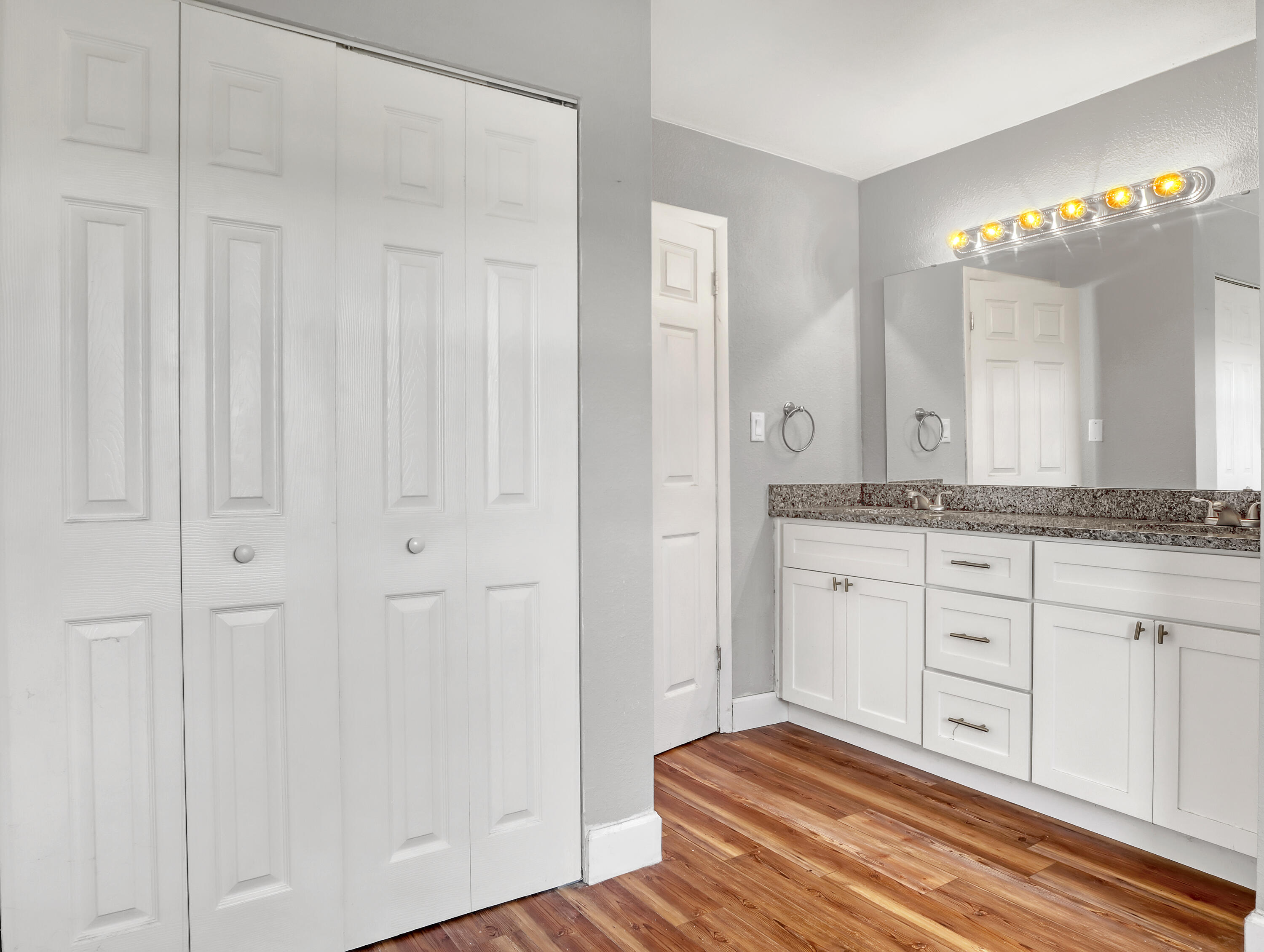 2711 Locksley Road Melbourne, FL 32935 - Photo 20 of 34 a spacious bathroom with a granite countertop sink and a mirror