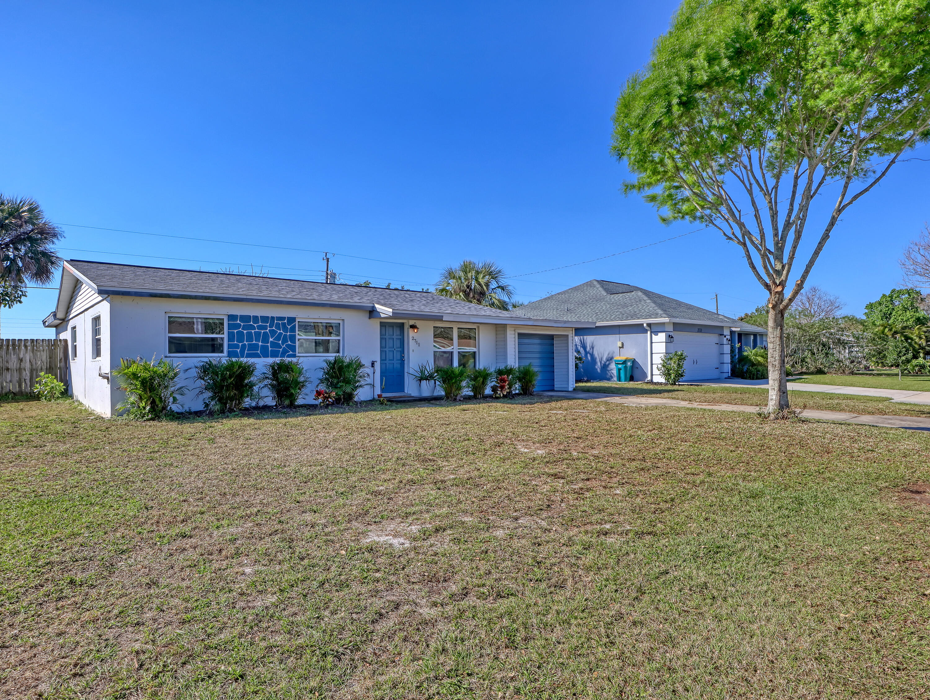 2711 Locksley Road Melbourne, FL 32935 - Photo 2 of 34 a front view of a house with a garden