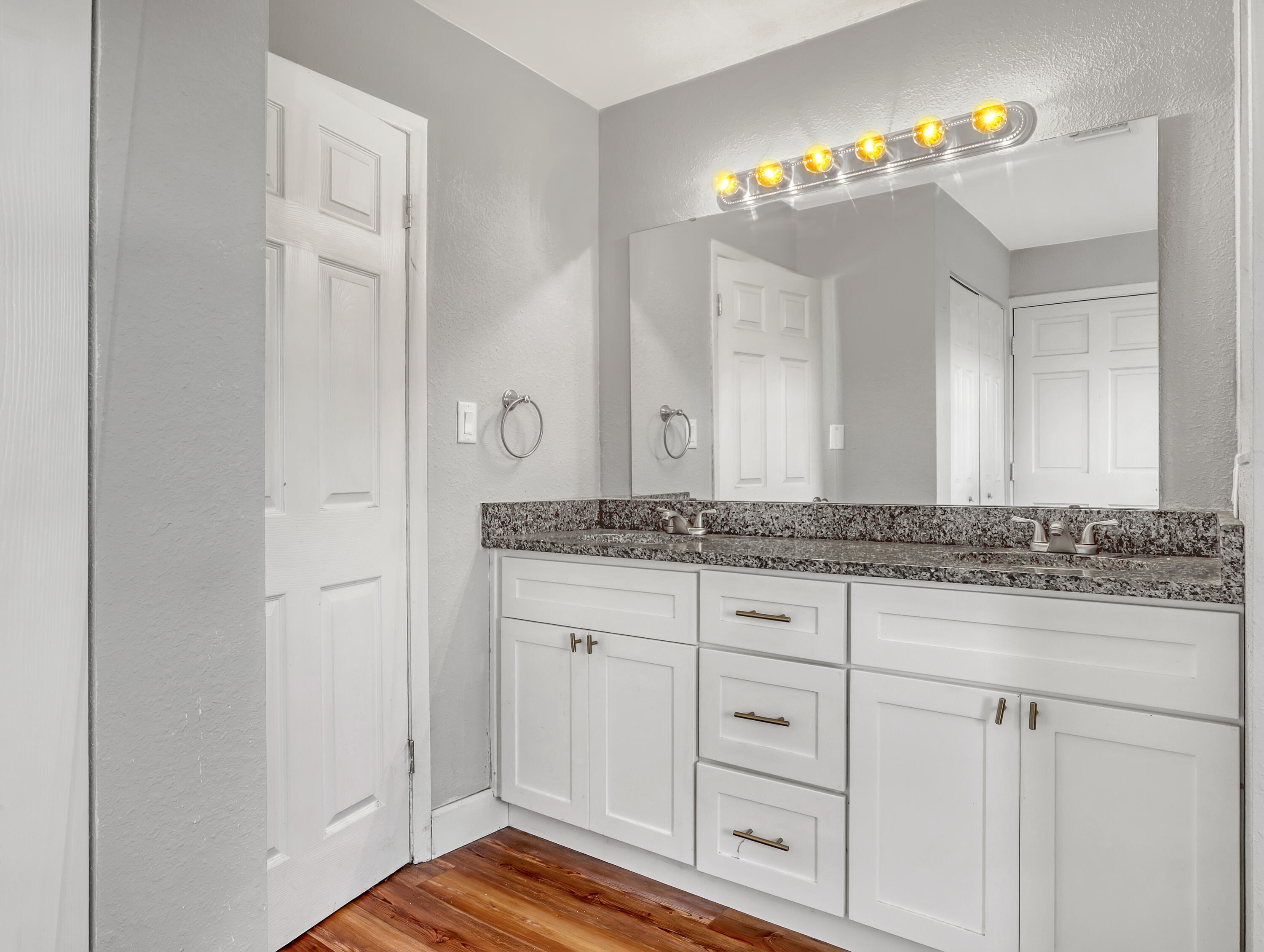 2711 Locksley Road Melbourne, FL 32935 - Photo 21 of 34 a bathroom with a granite countertop sink and a mirror