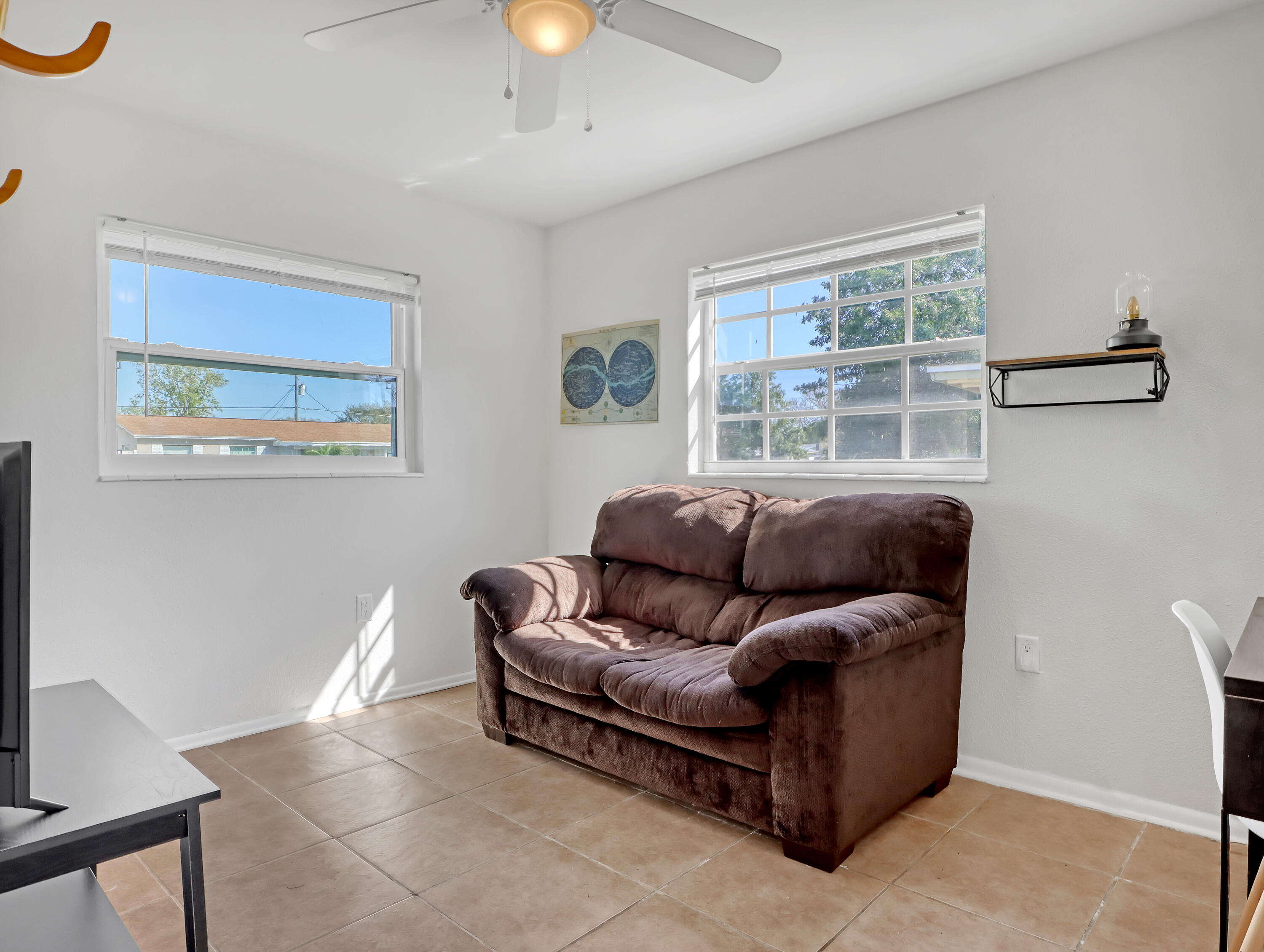 2711 Locksley Road Melbourne, FL 32935 - Photo 24 of 34 a living room with furniture and a window