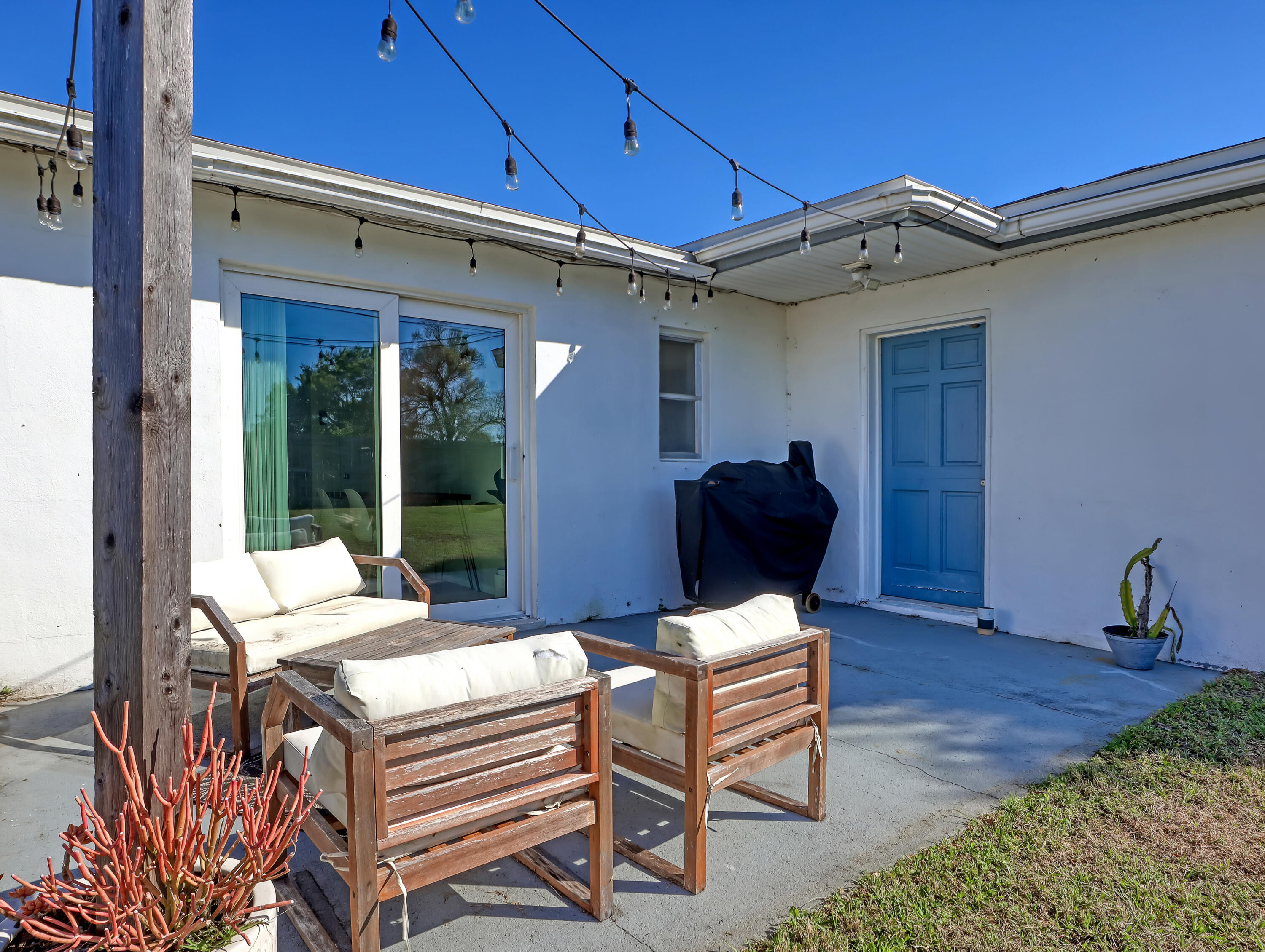 2711 Locksley Road Melbourne, FL 32935 - Photo 30 of 34 a outdoor space with patio the couches and a potted plant on the table