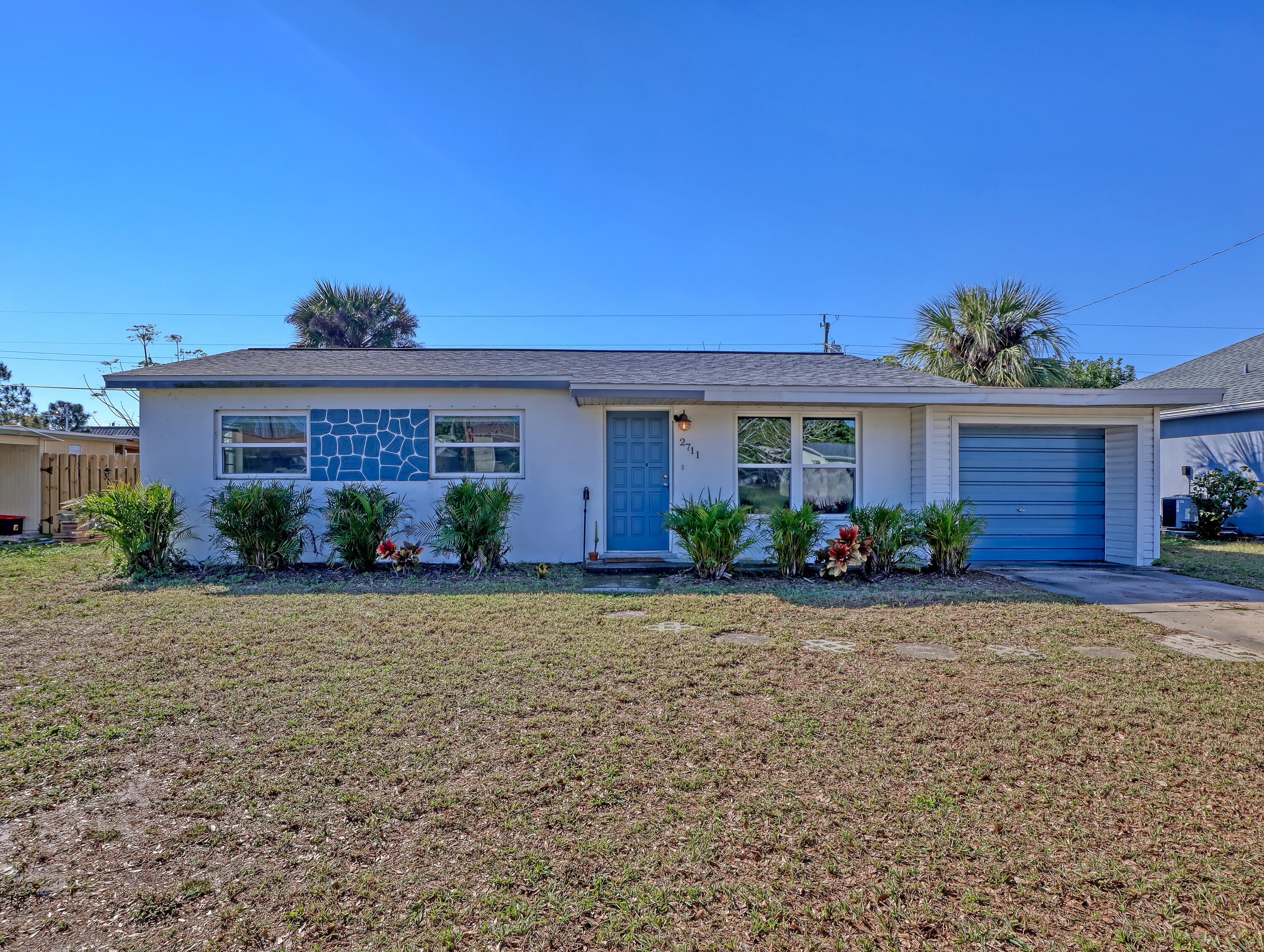 2711 Locksley Road Melbourne, FL 32935 - Photo 3 of 34 front view of a house with a yard