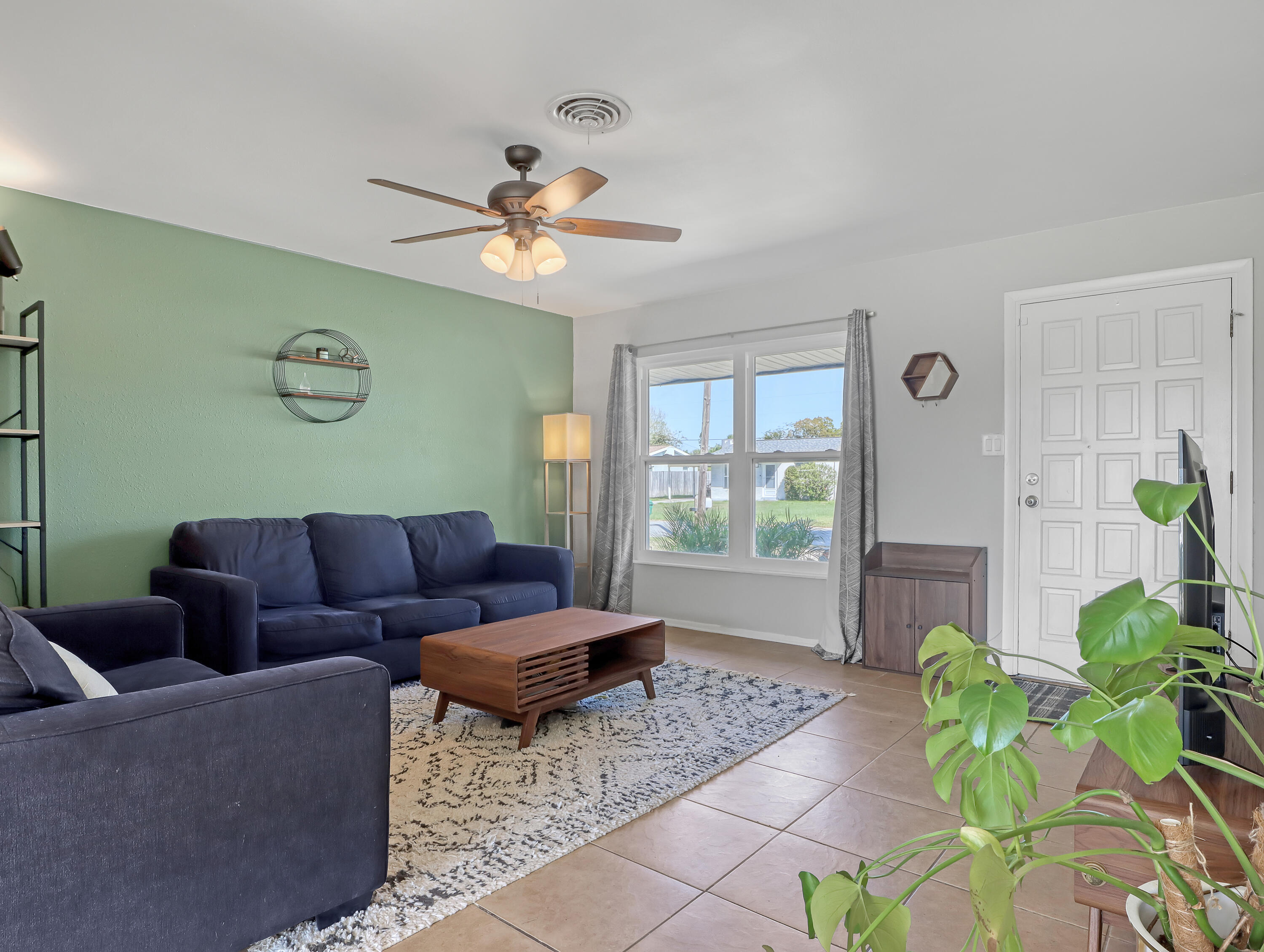 2711 Locksley Road Melbourne, FL 32935 - Photo 7 of 34 a living room with furniture and a potted plant