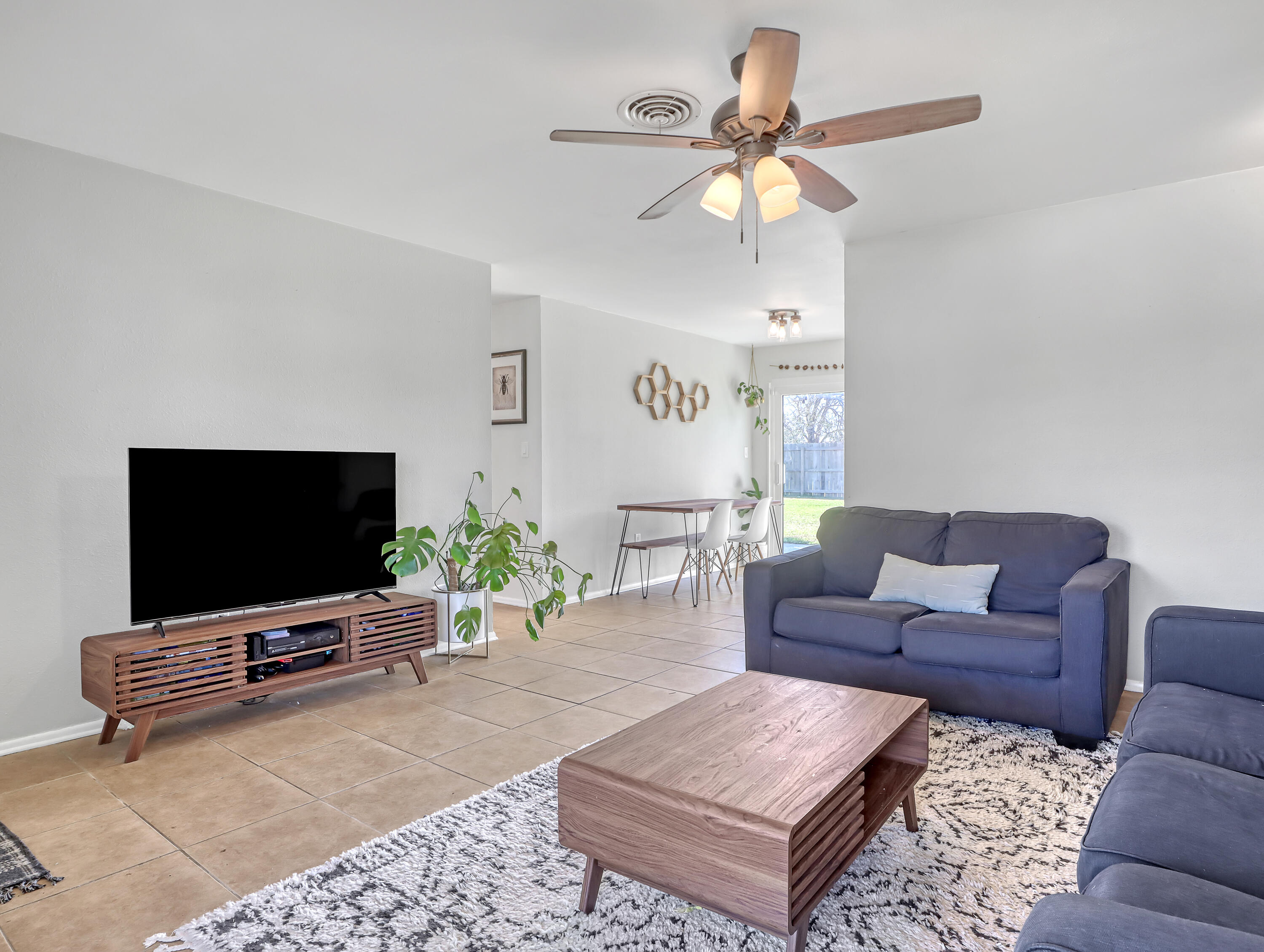 2711 Locksley Road Melbourne, FL 32935 - Photo 8 of 34 a living room with furniture and a flat screen tv