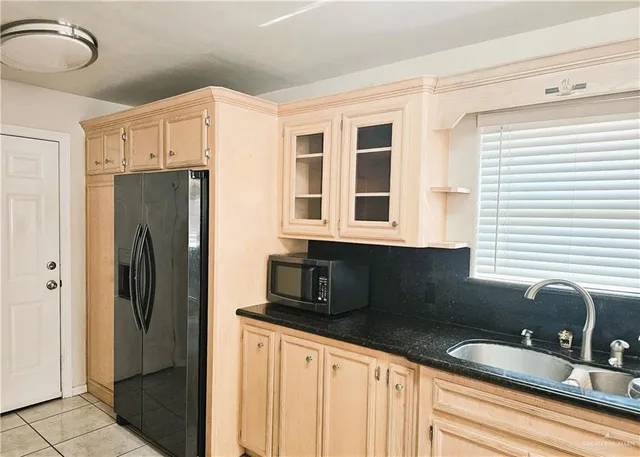 a kitchen with stainless steel appliances granite countertop a refrigerator and a sink