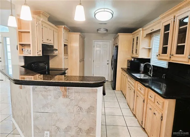 a kitchen with stainless steel appliances granite countertop a sink and cabinets