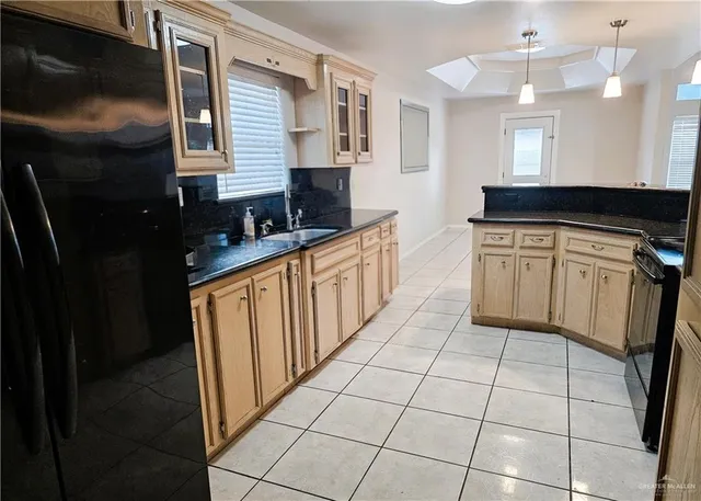 a kitchen with stainless steel appliances a sink stove and cabinets