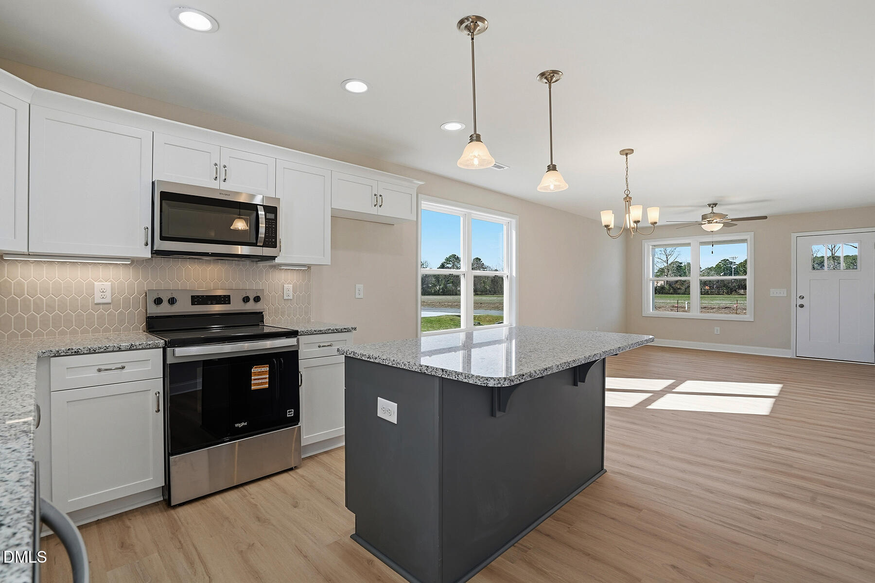 232 Rae Street Warsaw, NC 28398 - Photo 12 of 31 a kitchen with stainless steel appliances kitchen island granite countertop a stove a sink and a wooden floor