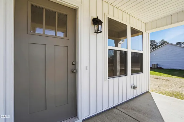 a view of kitchen with stove and cabinets