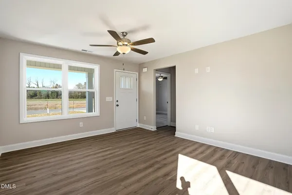 a view of a kitchen with wooden floor and a ceiling fan