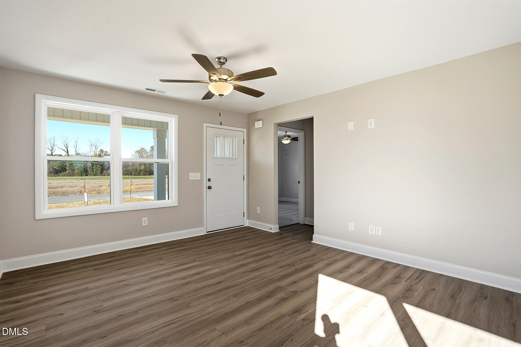 232 Rae Street Warsaw, NC 28398 - Photo 7 of 31 a view of an empty room with wooden floor and a window