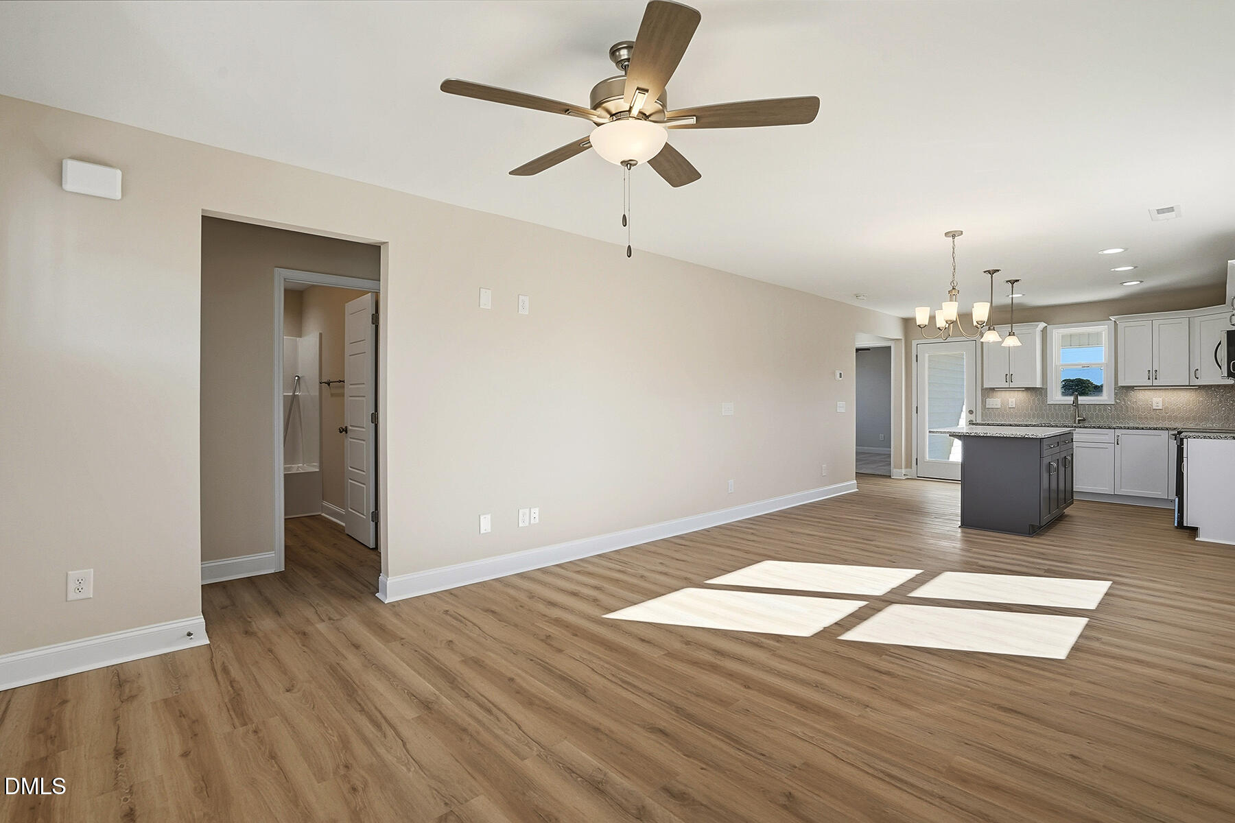 232 Rae Street Warsaw, NC 28398 - Photo 8 of 31 a view of a kitchen with wooden floor and a ceiling fan