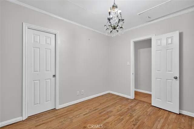 a view of a chandelier in big room with wooden floor