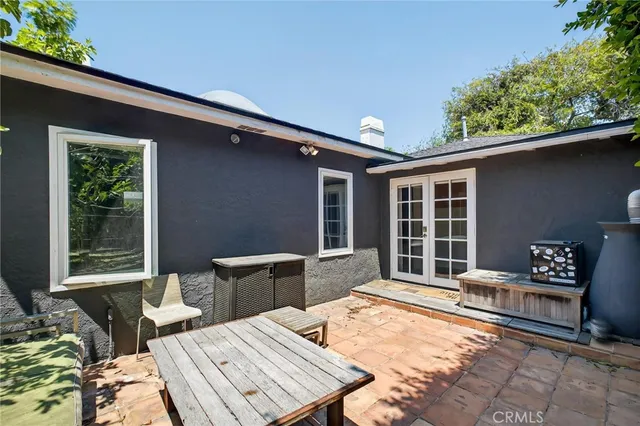 a balcony with furniture and a potted plant