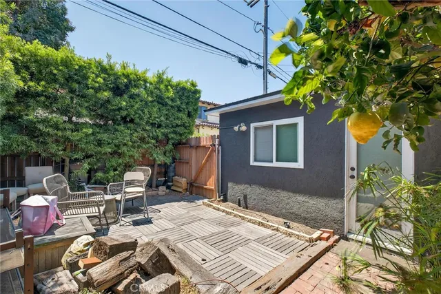 a view of a patio with table and chairs and potted plants