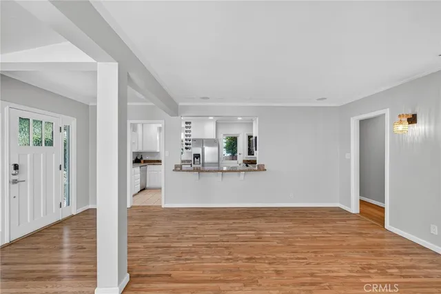 a view of a living room with wooden floor