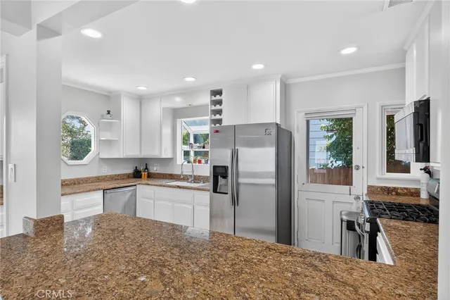 a kitchen with a refrigerator and a sink