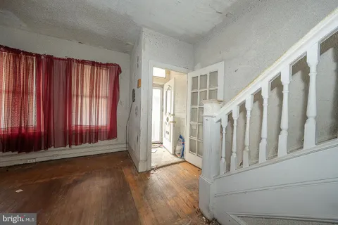 a view of a room with wooden walls and windows