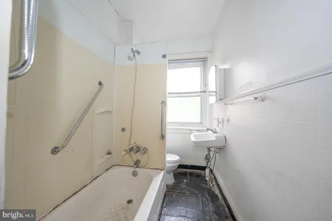 a bathroom with a sink a toilet and a bathtub