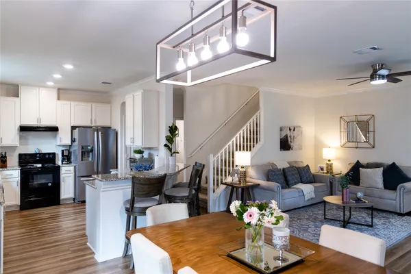 a living room with fireplace furniture and a wooden floor