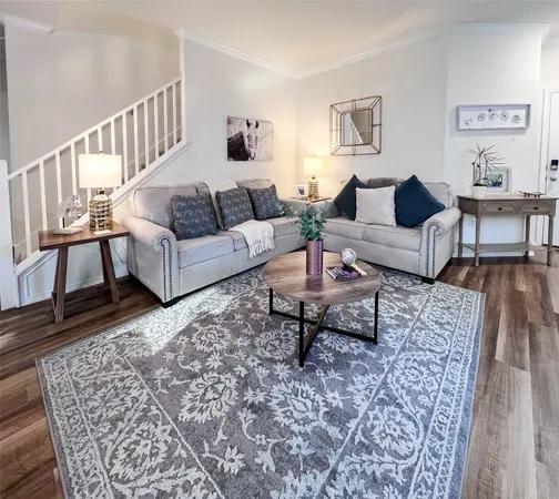 a living room with furniture and a rug