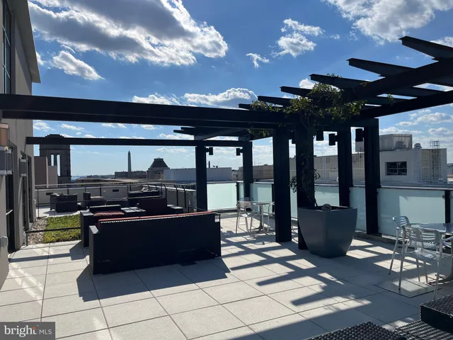 a view of a patio with dining table and chairs