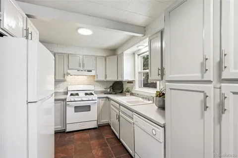 a kitchen with a stove sink and refrigerator