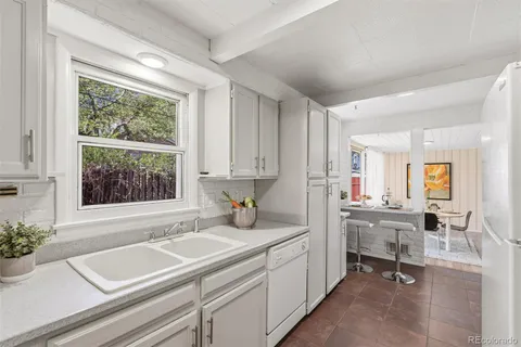 a kitchen with a sink cabinets and window