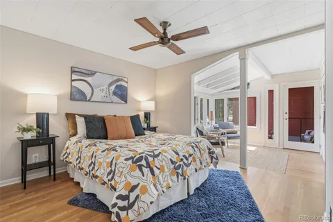 a bed room with a bed and painting on the wall