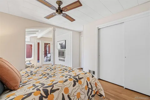 a bedroom with a large bed and a chandelier