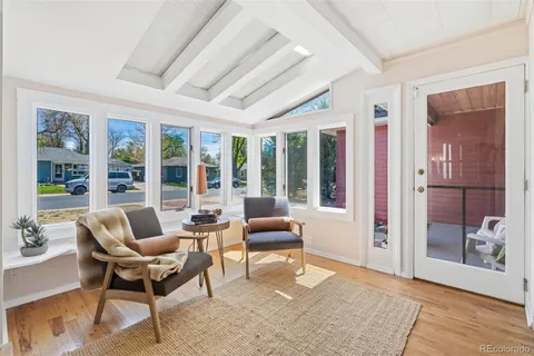 a living room with furniture and large windows