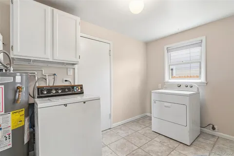 a kitchen with a sink a stove and cabinets