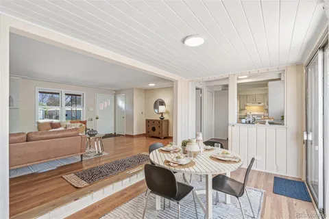 a view of a dining room with furniture and wooden floor