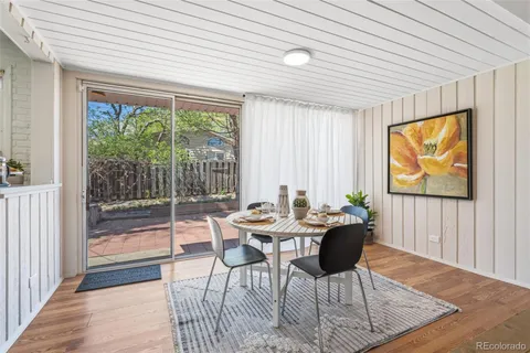 a dining room with furniture and wooden floor