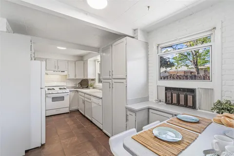 a kitchen with stainless steel appliances granite countertop a stove and a refrigerator