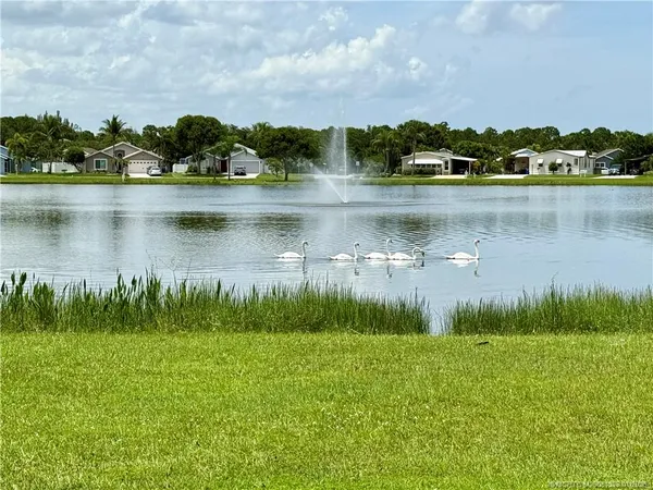 a view of a lake with houses in the back