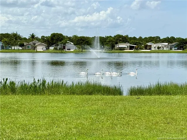 a view of a lake with houses in the back