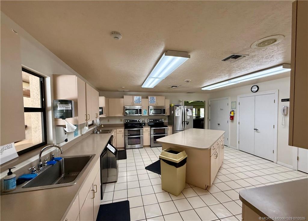 2574 Southwest Monarch Trail Stuart, FL 34997 - Photo 16 of 21 a large kitchen with a large window and table