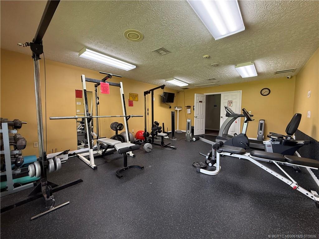 2574 Southwest Monarch Trail Stuart, FL 34997 - Photo 19 of 21 a view of a room with gym equipment